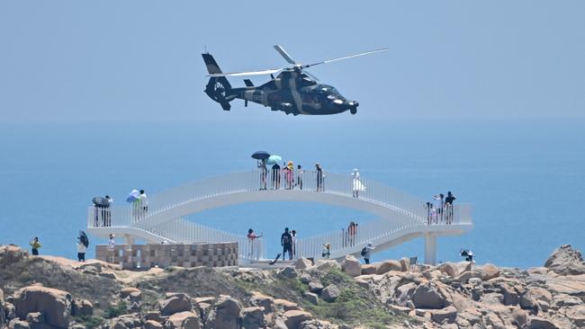 A Chinese military helicopter flies past Pingtan island, one of mainland China's closest point from Taiwan. Picture: AFP