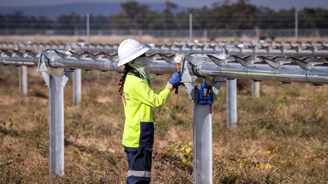 A worker checks newly constructed metal frames for photovoltaic modules at a solar farm on the outskirts of Gunnedah, New South Wales. Photographer: David Gray/Bloomberg via Getty Images