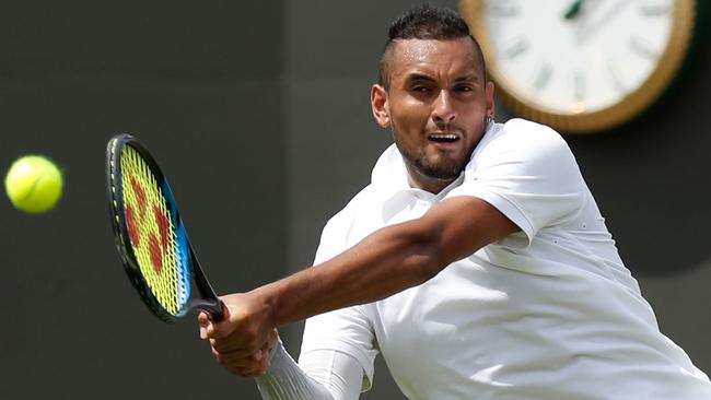 Nick Kyrgios returns the ball against countryman Jordan Thompson during their singles first round match at Wimbledon on Tuesday. Picture: AFP