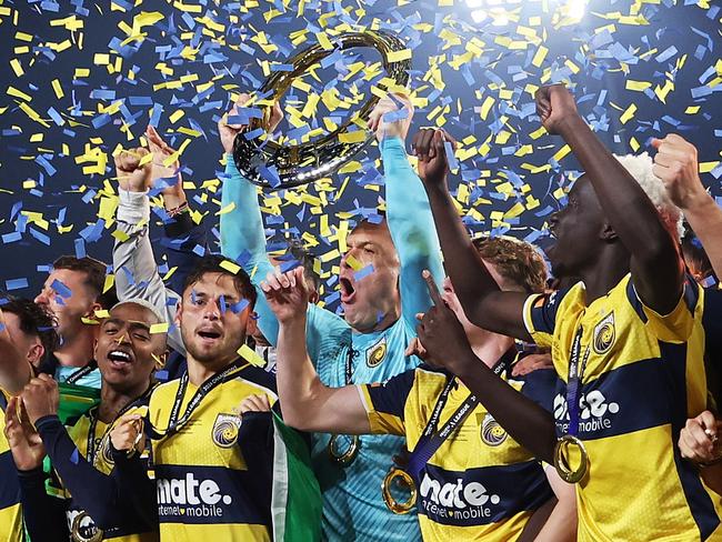 GOSFORD, AUSTRALIA - MAY 25: Danny Vukovic of the Central Coast Mariners holds aloft the Championship Trophy alongside team mates after winning the A-League Men Grand Final match between Central Coast Mariners and Melbourne Victory at Industree Group Stadium, on May 25, 2024, in Gosford, Australia. (Photo by Mark Metcalfe/Getty Images)