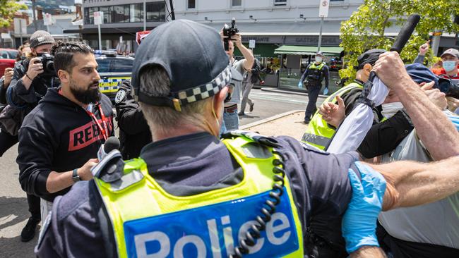 Avi Yemeni clash with protesters. Anti Fascist protesters mach through Carlton.NOT PICTURED:  Freedom Rally Protesters gather at the Victorian State Parliament in Melbournes CBD to protest Covid vaccine mandates the new pandemic Bill and various other causes. Large numbers of police at the rally. Picture: Jason Edwards