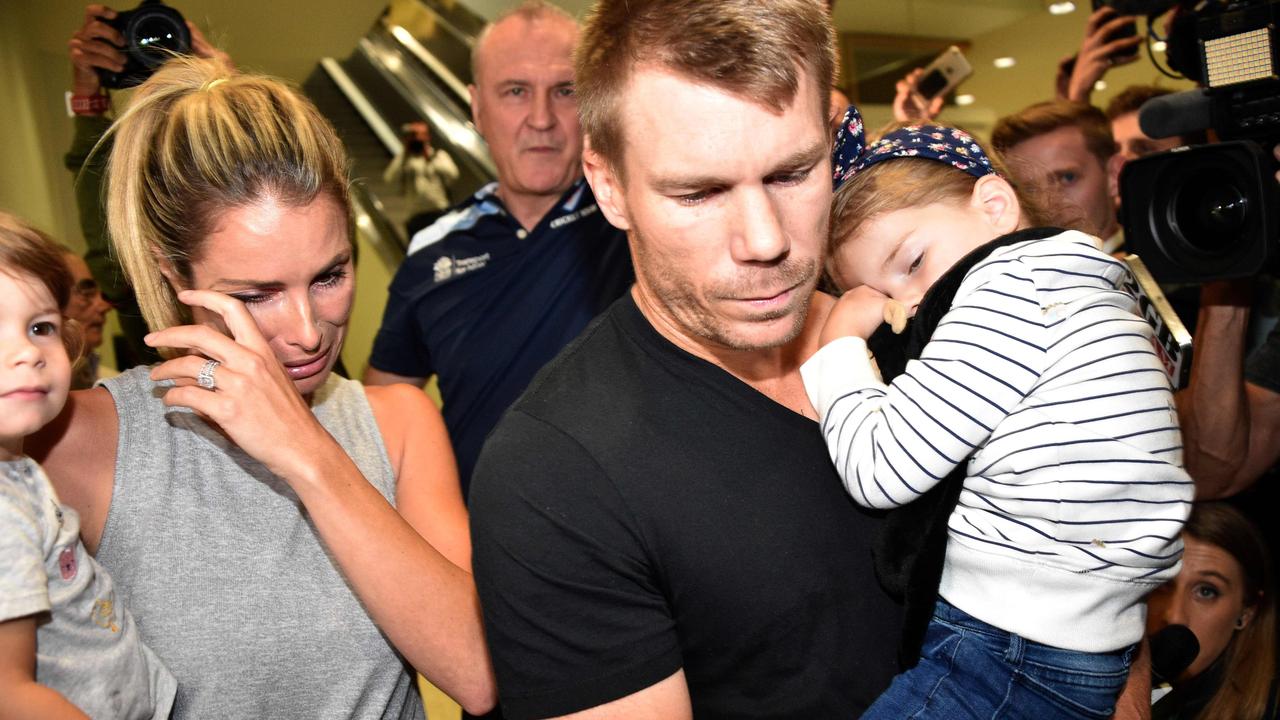 David Warner, his wife Candice and their daughters leaving the airport after arriving back in Sydney from South Africa