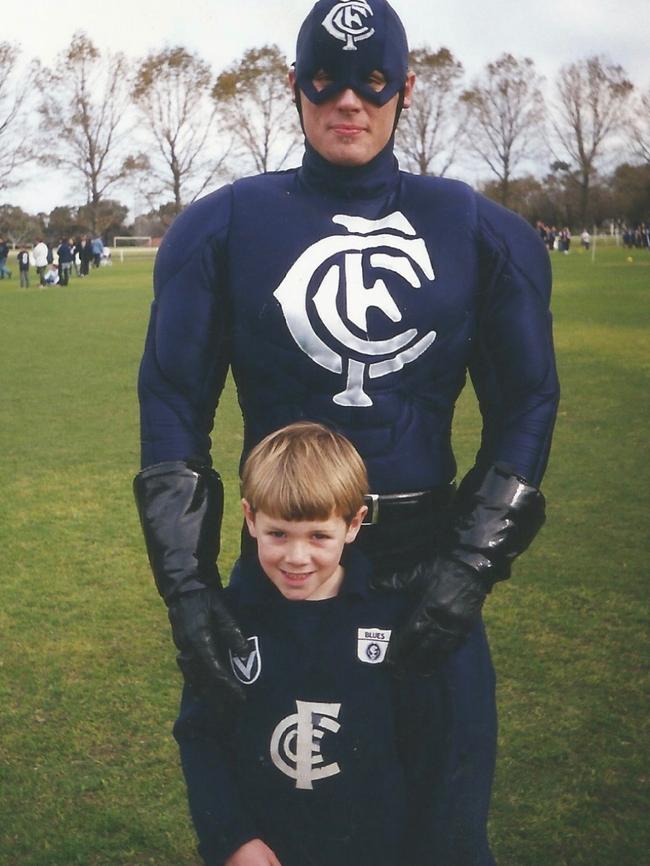 Young Carlton fan Sam Docherty with Blues mascot Captain Carlton.