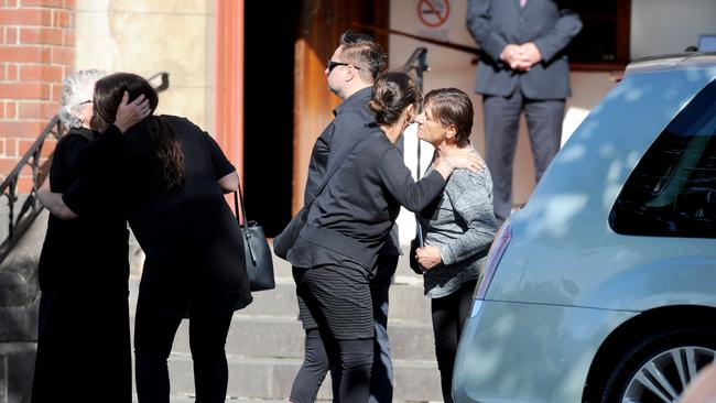 Mourners greet each other before walking into the church. Picture: AAP