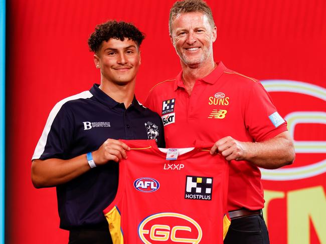 MELBOURNE, AUSTRALIA - NOVEMBER 20: Jake Rogers is seen with Damien Hardwick, Senior Coach of the Suns after being selected at number 14 during the 2023 AFL Draft at Marvel Stadium on November 20, 2023 in Melbourne, Australia. (Photo by Michael Willson/AFL Photos via Getty Images)