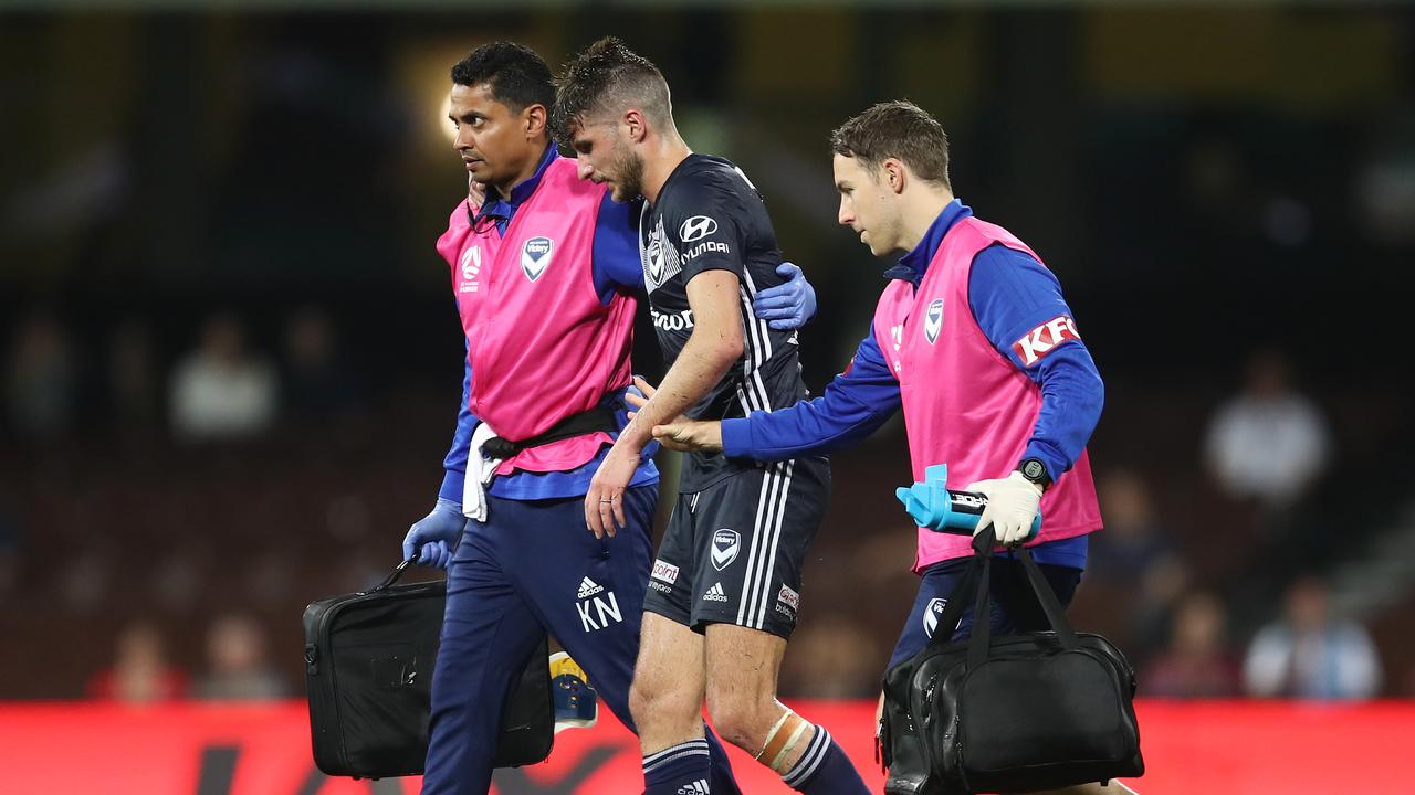 Terry Antonis of the Victory is helped from the field after suffering a suspected knee injury.