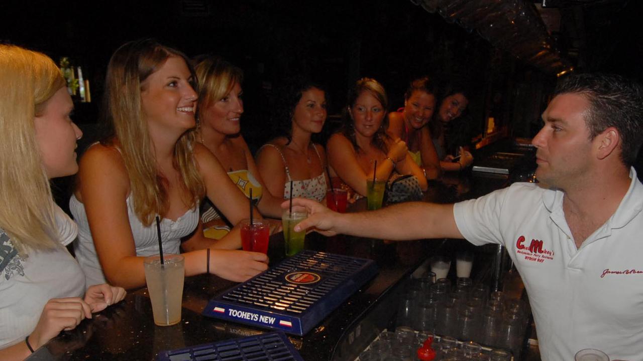 Ex Cheeky Monkey's manager Jacob Sweetapple serves drinks to backpackers from Canada and UK in 2007. Picture: Paul Riley