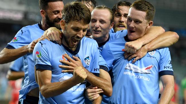 Milos Ninkovic of Sydney, (second left), celebrates with team mates. (AAP Image/Dan Himbrechts)