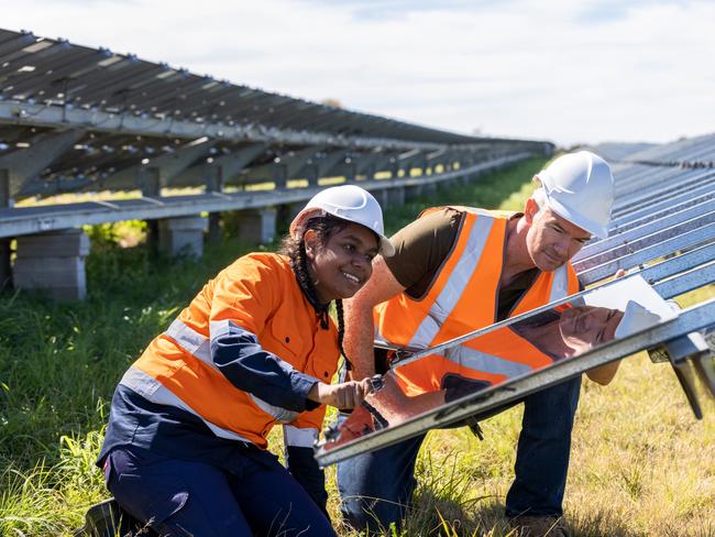 Senior Engineer and Aboriginal Australian Apprentice Working Together On Solar Farm Installation