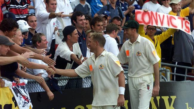 Shane Warne and Glenn McGrath shake hands with English fans after a Test match.