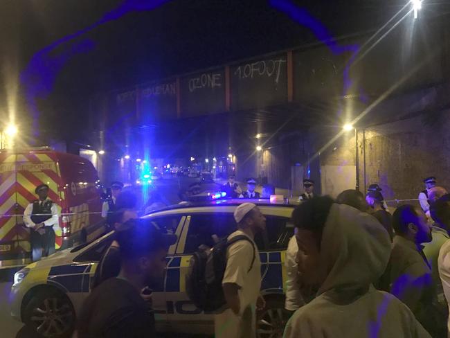 Crowds fill Seven Sisters Road in the early hours of Monday morning after a van collided with pedestrians. Picture: Lexie Cartwright