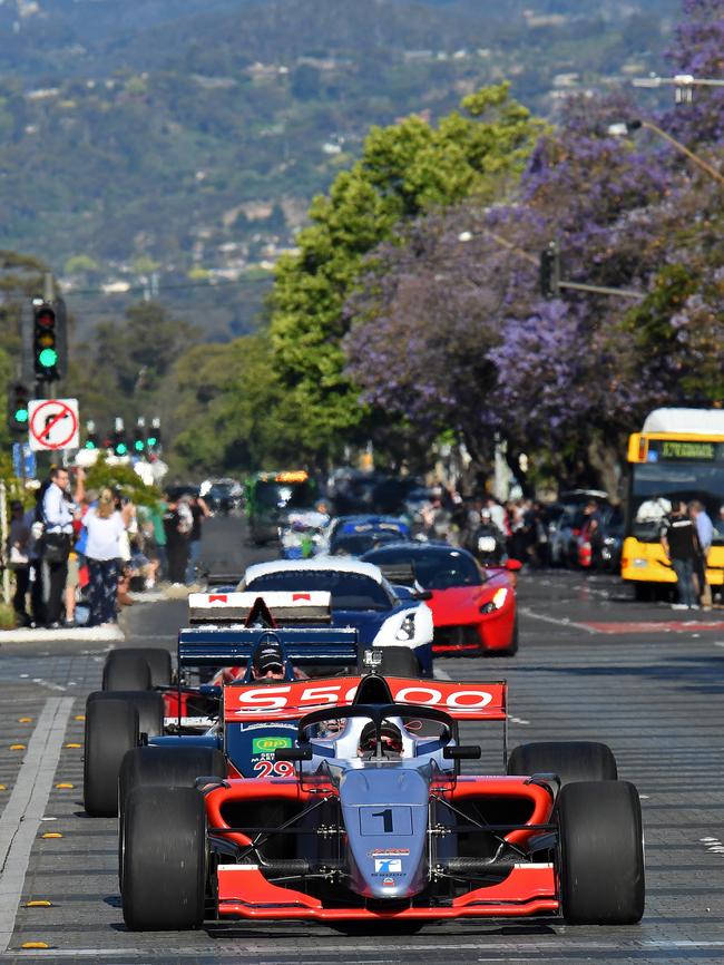 Race cars head down Wakefield Street through Victoria Square for the Adelaide Motorsport Festival’s Peak Hour of Power. Picture: Tom Huntley