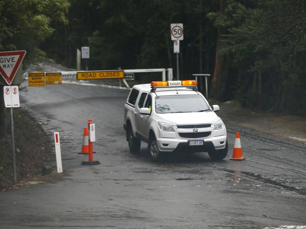 Strong Southerly winds have brought snow to Kunanyi / Mount Wellington over night. Signs showing that the Mountain is closed to vehicles. Picture: MATT THOMPSON