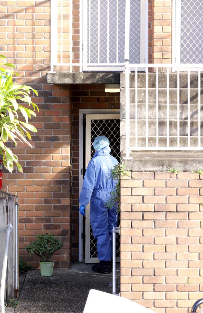 Police at the scene where 45-year-old woman has been found dead at a unit in Annerley. Photo: Steve Pohlner