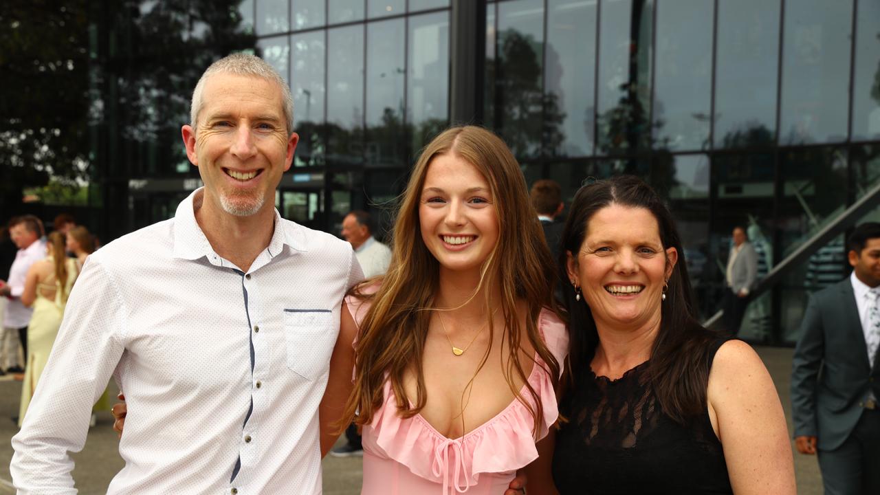 Bella Wright with parents Tim and Bianca at the Belmont High School year 12 graduation at GMHBA Stadium. Picture: Alison Wynd