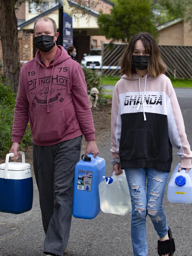 Robert Fox and his daughter get a supply of drinking water for home. Picture: Sarah Matray