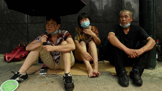 People gather at Evergrande headquarters in Shenzhen on Thursday after the Chinese property giant said it was facing ‘unprecedented difficulties’. Picture: AFP