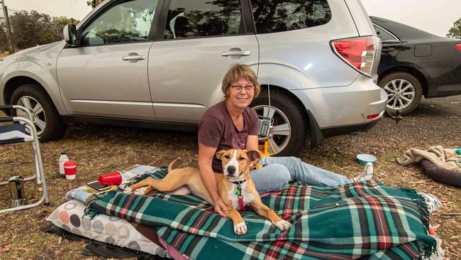 Mandy and her dog are happy to reach safety. Picture: Jason Edwards