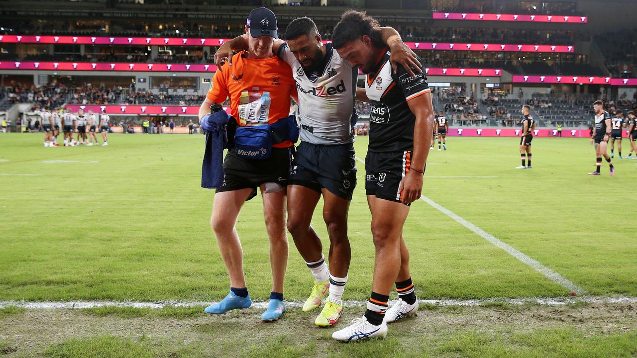 George Jennings helped off by opposition player Kelma Tuilagi (right).