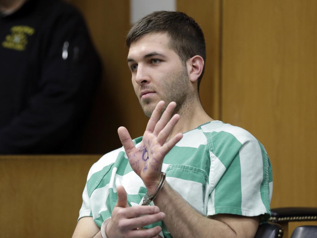 Anthony Comello displays writing on his hand that includes pro-Donald Trump slogans and the letter ‘Q’. Picture: Seth Wenig/AP