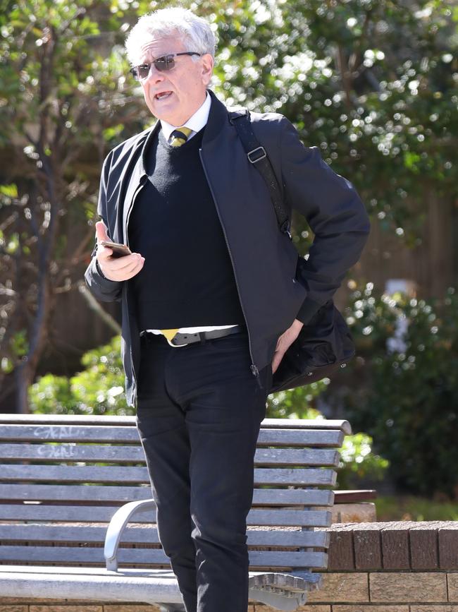 Michael Podgoetsky without a mask while waiting for a bus. Picture: John Grainger