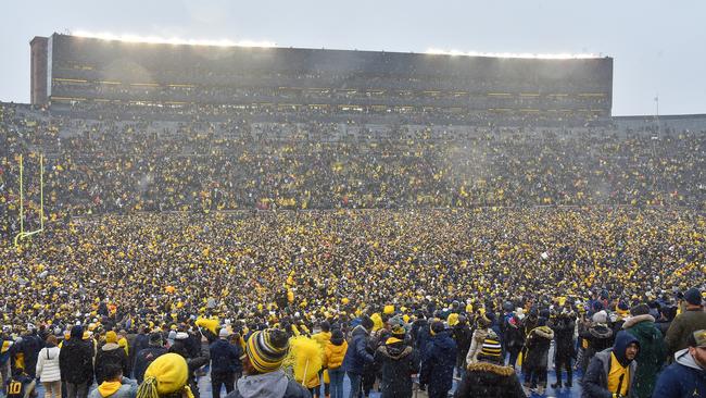 ANN ARBOR, MI - NOVEMBER 27: Michigan fans rush the field celebrating the 42-27 victory by The Michigan Wolverines vs the Ohio State Buckeyes game on Saturday November 27, 2021 at Michigan Stadium in Ann Arbor, MI. (Photo by Steven King/Icon Sportswire via Getty Images)