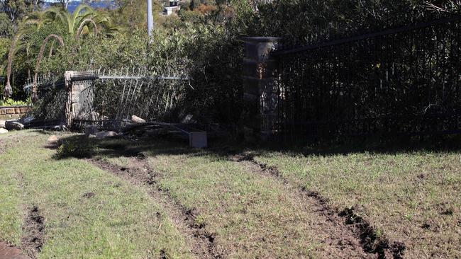 The scene of the car crash in Caladenia Cl, Elanora Heights, the morning after a car, with six teens on-board, smashed through a stone and iron fence late on July 18. Picture: David Swift