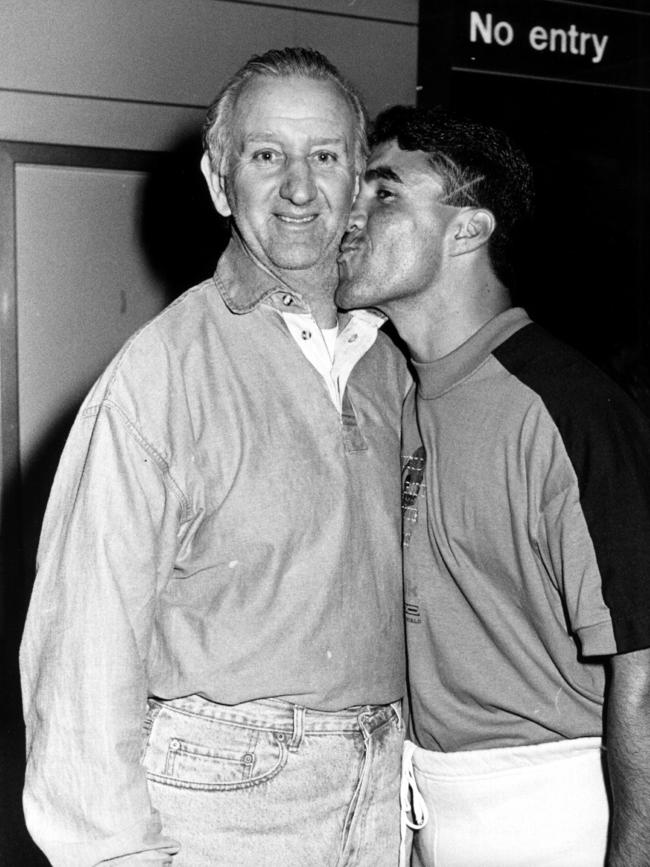 Lewis (left) being greeted by boxer Jeff Fenech at Sydney Airport in 1990. Picture: Chris Pavlich