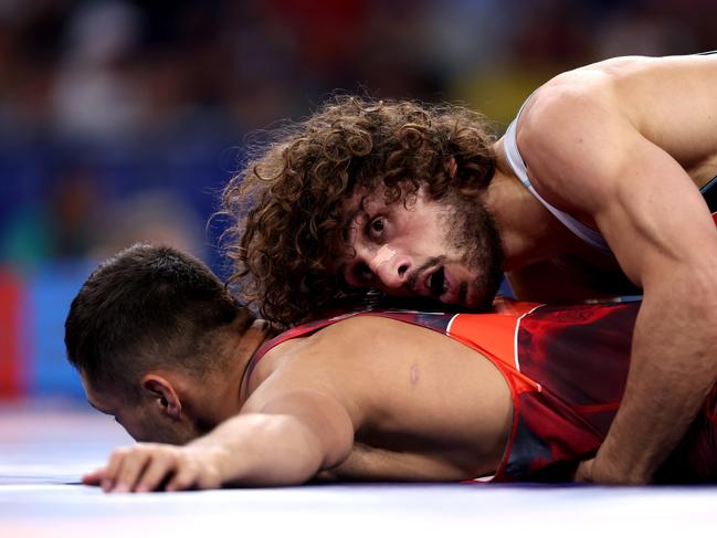 PARIS, FRANCE - AUGUST 07: Amantur Ismailov of Team Kyrgyzstan and Ramaz Zoidze of Team Georgia compete during the MenÃ¢â¬â¢s Greco-Roman 67kg 1/8 Final match between Amantur Ismailov of Team Kyrgyzstan and Ramaz Zoidze of Team Georgia on day twelve of the Olympic Games Paris 2024 at Champs-de-Mars Arena on August 07, 2024 in Paris, France. (Photo by Sarah Stier/Getty Images)