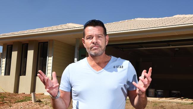 Rod Mattingley outside his unfinished home in Griffin.