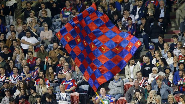 A Knights fan flies a flag in support at McDonald Jones Stadium in Newcastle. Picture: AAP