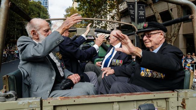 Veterans ride in the back of a Land Rover during the march in Sydney. Picture: Max Mason-Hubers.