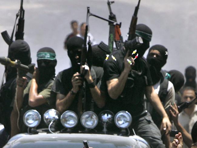 14/06/2007 WIRE: Palestinian militants from Hamas ride on a truck with their weapons behind the body of milItant Emad Abu Kados who was killed during clashes with Fatah gunmen in the Sheikh Radwan neighborhood in Gaza City, Wednesday, June 13, 2007. Fierce battles over key security positions spread to central and southern Gaza early Wednesday, with Hamas fighters wresting control of the coastal strip's main road, and took control of a major security compound in the southern Gaza Strip town Khan Younis. The violence in Gaza has rapidly spiraled toward all-out civil war, with more than 50 reported killed since Monday.(AP Photo/Hatem Moussa)