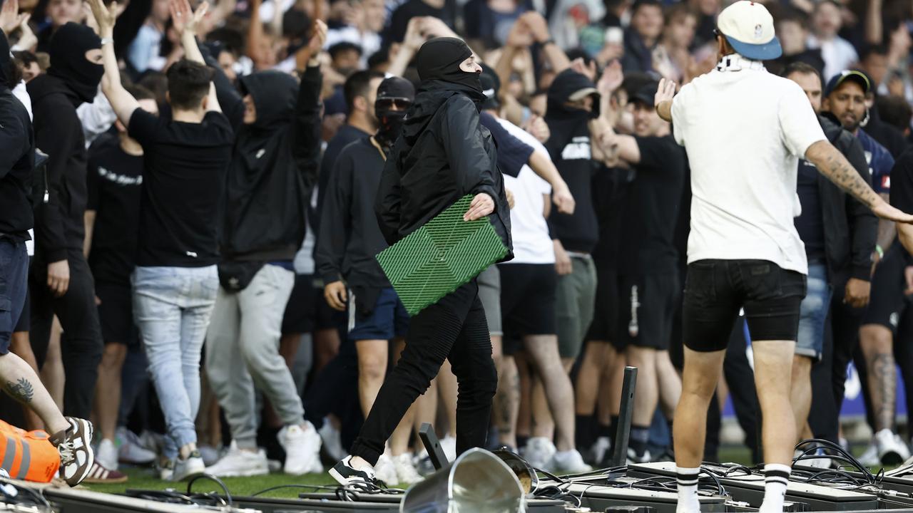 A lone fan tries to turn back crazed supporters hellbent on causing as much trouble as possible. Picture: Darrian Traynor/Getty Images