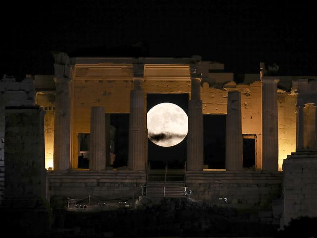 The moon rises behind the Propylaia at the Acropolis hill in Athens, Monday, Nov. 14, 2016. The brightest moon in almost 69 years will be lighting up the sky this week in a treat for star watchers around the globe. Picture: AP Photo/Yorgos Karahalis