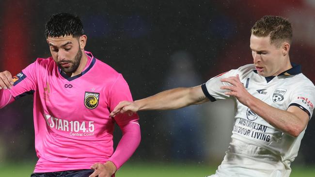 GOSFORD, AUSTRALIA - MAY 01: Christian Theoharous of the Mariners is tackled by Harry Van der Saag of Adelaide United  during the A-League Men round 25 match between Central Coast Mariners and Adelaide United at Industree Group Stadium, on May 01, 2024, in Gosford, Australia. (Photo by Scott Gardiner/Getty Images) (Photo by Scott Gardiner/Getty Images)