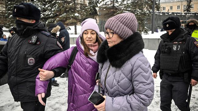 Police detain a woman in Moscow as people come to the monument to the victims of political repression. Picture: AFP