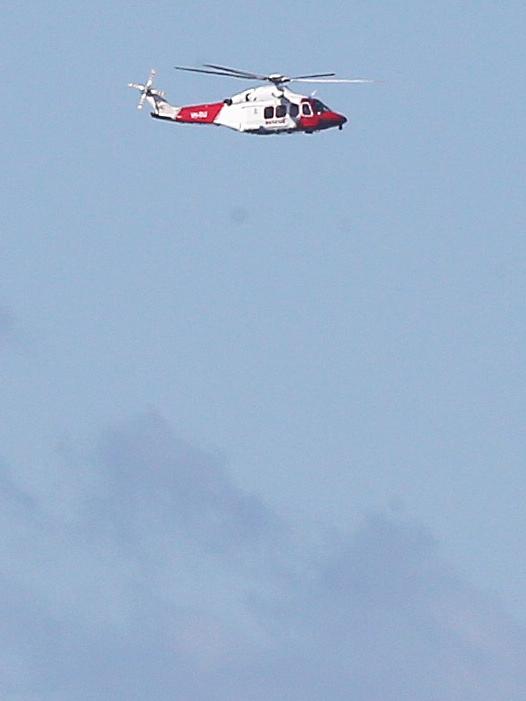 A search helicopter at the scene today. Picture: Peter Lorimer