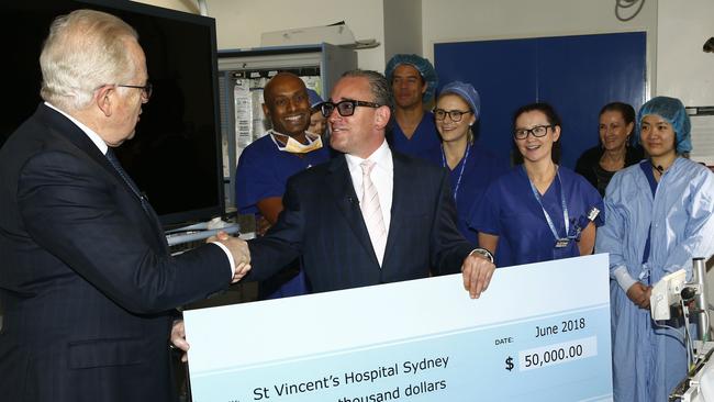 Carlo Massetti handing over a cheque to St Vincents Hospital. Picture: John Appleyard