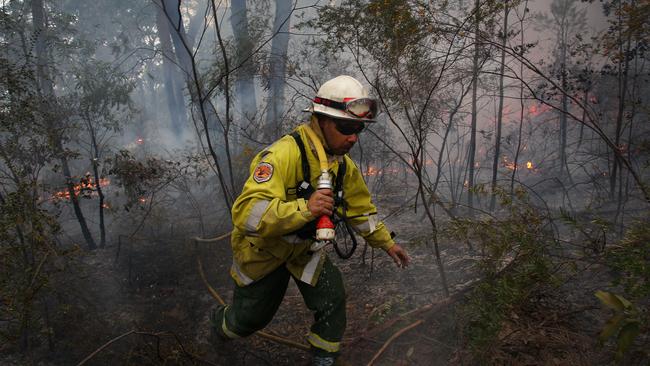 A field officer with the NSW National Parks and Wildlife Service in Dubbo monitors a hazard reduction burn at Bowen Mountain. Picture: Getty Images