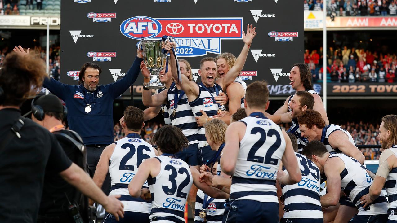 Joel Selwood is mobbed by teammates on the dais after the Grand Final.