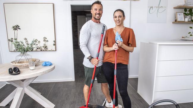 Isaac Lappin and Aimee Wells from C&K Property in Withcott finish cleaning their premises. Monday, February 28, 2022. Picture: Nev Madsen.