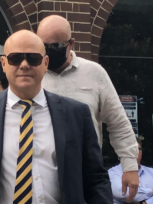 Anthony Kerry Bain (rear), 49, of Elanora Heights, leaves Manly Courthouse, with his solicitor Craig Murray. Picture: Jim O'Rourke