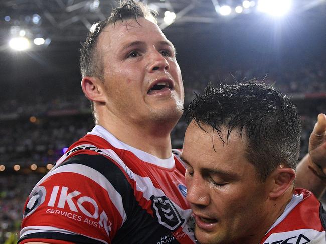 Brett Morris and Cooper Cronk of the Roosters celebrate following their win in the 2019 NRL Grand Final between the Canberra Raiders and the Sydney Roosters at ANZ Stadium in Sydney, Sunday, October 6, 2019. (AAP Image/Dan Himbrechts) NO ARCHIVING, EDITORIAL USE ONLY