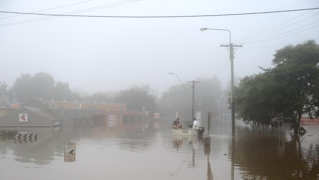 A boat heads out to start the early morning clean up at the peak of the flood Gympie flood January 2013 Photo Craig Warhurst / The Gympie Times