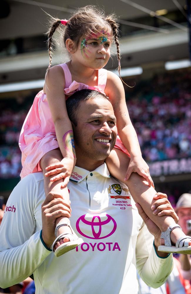 Usman Khawaja celebrates with his family after Australia win the Border-Gavaskar trophy in Sydney. Photo: Tom Parrish