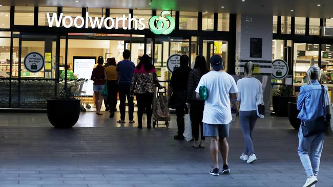 Queue outside Woolworths after supermarkets placed restrictions on the number of customers allowed in the store. Picture: Nikki Short