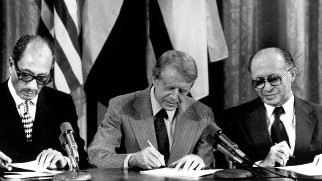 Egyptian President Anwar Sadat, US President Jimmy Carter, and Israeli Prime Minister Menachem Begin sign one of two agreements forged at the Camp David Summit. Picture: AP