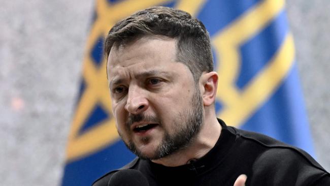Ukrainian President Volodymyr Zelensky gestures as he gives a press conference in Kyiv on February 24, 2023, on the first anniversary of the Russian invasion of Ukraine. (Photo by Genya SAVILOV / AFP)
