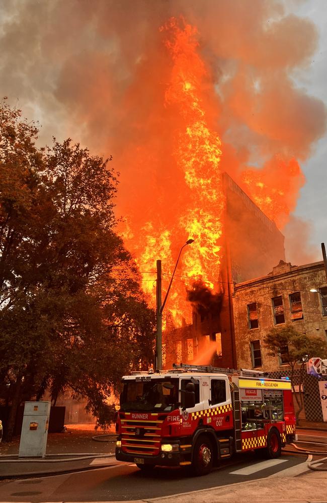A fire engulfs an empty building in Surry Hills. The structure later collapsed and two 13-year-olds charged with setting the blaze. Picture: Neil Bennett